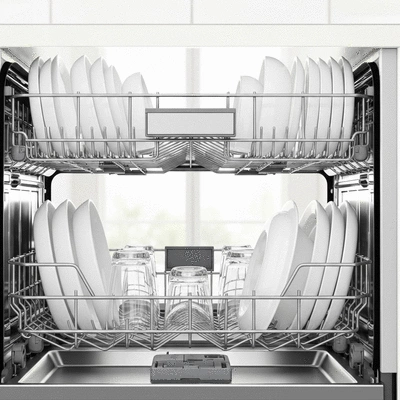 Close up of a clean modern dishwasher interior with sparkling plates and glassware